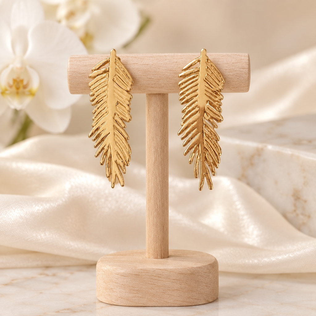 Boucles plumes dorées sur un présentoir en bois dans un décor chic